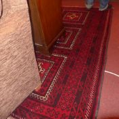 A fine North East Persian Turkoman rug 210 x 120 cm repeating panel motifs on a rouge field within