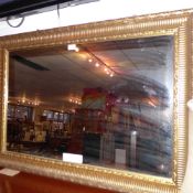 A contemporary wall mirror the rectangular plate within a gilt frame