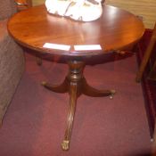 A mahogany occasional table the circular top raised on triform supports