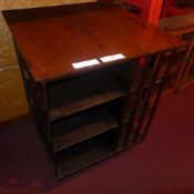 A C19th oak revolving bookcase of three tiers on pedestal base and brass paw feet