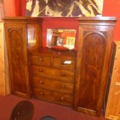 A Victorian mahogany wardrobe fitted two short and three long central drawers flanked by twin