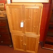 A pair of contemporary pine cabinets fitted pair of panel doors enclosing shelves