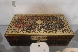A Boulework design box with inlaid brass and tortoiseshell and a green leather interior containing