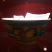 A Chinese bowl with brightly coloured glaze and dragons in relief