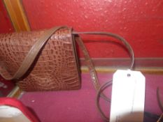 A ladies crocodile skin hand bag