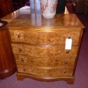 A burr walnut serpentine fronted chest fitted four long drawers on bracket feet