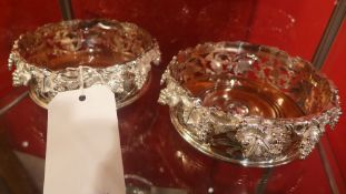 A silver plated wine coaster with grapevine detail in relief
