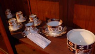 A set of six Sutherland porcelain coffee cups and saucers together with a similar cup, saucer and