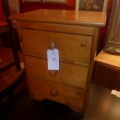 A pair of pine three drawers bedside chests