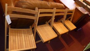 A set of four folding patio chairs