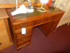 A yew wood pedestal desk the tooled leather top above arrangement of drawers