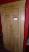 An old pine pantry cabinet of tall proportions fitted pair of panelled doors enclosing shelves
