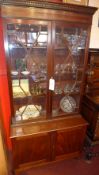 An Edwardian mahogany library bookcase fitted pair of cupboard doors on bracket feet