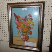 A gouache on paper still life study of flowers in a vase on a table in silvered frame