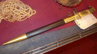 A military dagger with eagle head form handle and leather bound sheath