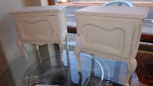 A pair of French painted distressed finish bedside tables fitted single panel door on cabriole
