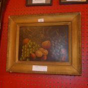 An Edwardian oil on board of fruit signed Reynolds in a gilt frame