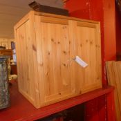 A pair of contemporary pine cabinets fitted pair of panel doors enclosing shelves