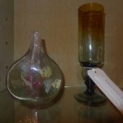An antique coloured glass with hollow stem having steel balls within and a similar vase