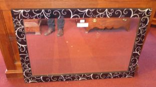 A rectangular Venetian style rectangular wall mirror having a bevelled plate