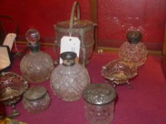 A collection of silver lidded perfume bottles, jars and similar as well as two silver plated bon bon