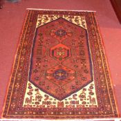 A handmade fine Persian Hamadan rug with three pole medallions on a chocolate field with ivory