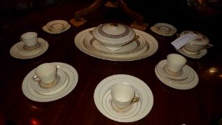 An Art Deco Empire Sovereign pattern part dinner set having gilding on an ivory ground