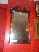A wall mirror with rectangular plate