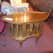 A retro walnut tray top cabinet with bevelled glazed sides on cabriole supports