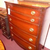 A mahogany tall chest of bow fronted outline fitted four long drawers with brass handles