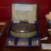 A C19th hallmarked silver clad brush and comb in original box