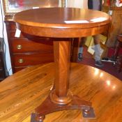 A Victorian mahogany occasional table the circular top raised on faceted support and platform base