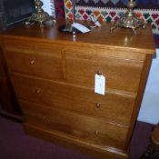 An Arts and Crafts oak chest fitted two short and two long drawers