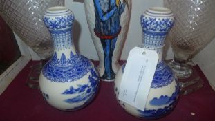A pair of Chinese blue and white vases decorated with pictoral reserves