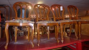 A set of four dining chairs with pierced backs above stuffover seats