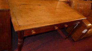A rectangular fruitwood kitchen table with two frieze drawers raised on turned supports