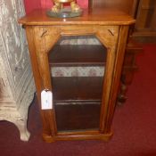 A Victorian inlaid walnut music cabinet fitted single glazed panel door on plinth base