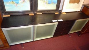 A contemporary Italian designer black laquered sideboard with three frosted glass doors flanking