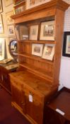 An old pine dresser the open shelf upstand above two drawers and pair of panelled doors on bracket