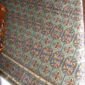 A Bokhara design runner having many guls on a green field 210 cm x 70 cm