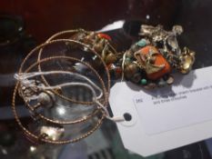 A sterling silver charm bracelet with three others and three brooches