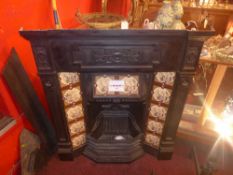 A late C19th cast iron fire place with original tile inserts