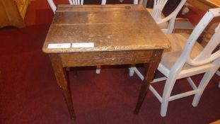 An old pine school desk raised on turned supports and pad feet