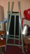 A pair of green painted easels of large size