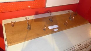A set of oak mounted coat hooks
