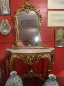 A Continental design giltwood console table and mirror having a marble top decorated with