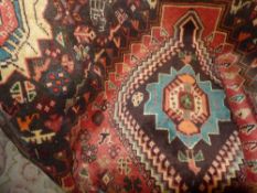 A Persian hand knotted Qashgai carpet the rust coloured ground having quadruple diamond pendants and