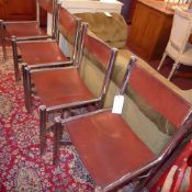 A set of four Italian designer chairs upholstered in tan leather on chromed supports