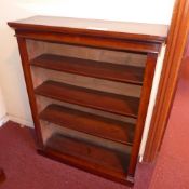 A Victorian walnut open bookcase with adjustable shelves on plinth base