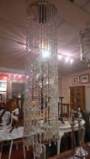A contemporary designer hanging light with string lustres